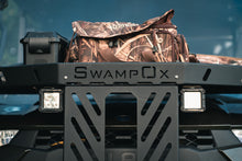 Load image into Gallery viewer, Direct closeup front view of UTV featuring Swamp Ox hood rack in outdoor setting during the day. Black textured powder-coated hood rack carrying outdoor gear.
