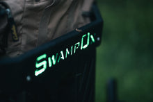 Load image into Gallery viewer, Closeup from above of green backlit Swamp Ox logo on front hood rack.
